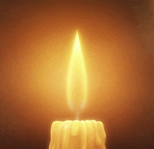 a candle is lit up in the dark with a flame coming out of it