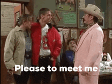 a man in a pink suit and cowboy hat is standing in front of a group of people and asking them to meet him .