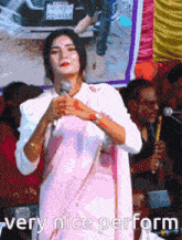 a woman singing into a microphone with the words " very nice perform " above her
