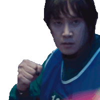 a man wearing a blue and green sweater is making a fist