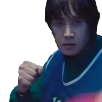 a man wearing a blue and green sweater is making a fist