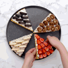 a person is putting a slice of cake with strawberries on it