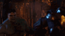 a man in a armored suit is standing next to another man