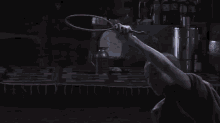 a man in a red shirt is holding a rope in his hand