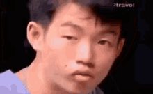 a close up of a young man 's face with a serious look on his face .