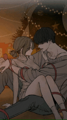 a man and a woman are sitting next to each other in front of christmas lights