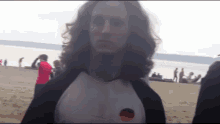 a man with long hair is wearing a shirt with a german flag on the side