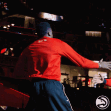 a man in a red shirt that says ' atlanta hawks ' on it