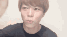 a close up of a young man making a funny face .