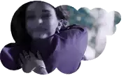 a woman in a purple sweater is hugging herself .