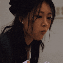 a close up of a woman 's face with a fork in front of her
