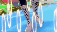a person wearing a pair of lace up boots is standing on a blue surface