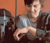 a pixelated image of a man looking at his wrist watch