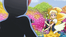 a girl in a yellow dress is holding a wand in a cartoon