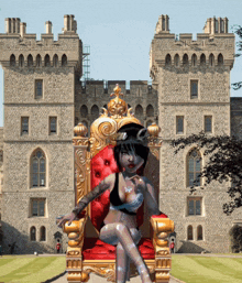 a woman is sitting on a throne in front of a large stone building