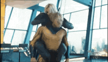 a man in a superhero costume is carrying a woman on his back