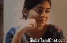a close up of a woman 's face with the website globaltamilchat.com visible in the corner