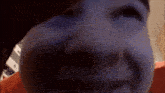 a close up of a person 's face with a purple background