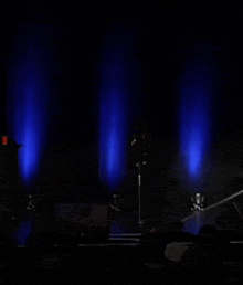 a dark stage with blue lights behind it