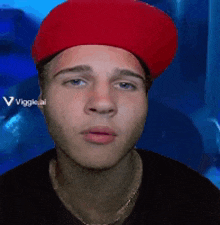 a man wearing a red hat is looking at the camera with the words viggle.ai in the background