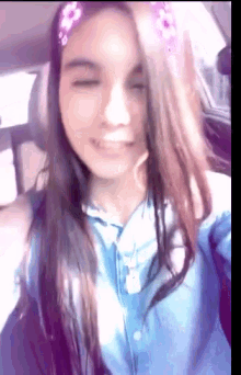 a girl wearing a headband with flowers on it