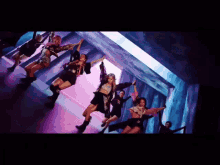 a group of women are dancing together in a room with their arms in the air .