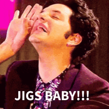 a man in a suit is laughing with the words jigs baby written above him
