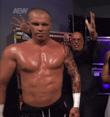 a shirtless wrestler stands in front of a wall that says aew