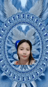 a woman is standing in a circle with feathers on her head and looking at the camera .