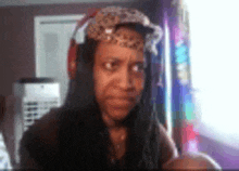 a woman wearing headphones and a hat is making a face .