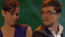 a man and a woman are sitting next to each other and the word regen is on the screen behind them
