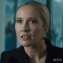 a close up of a woman 's face with a netflix logo in the background