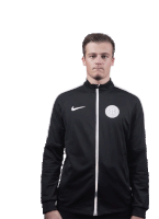 a man wearing a black nike jacket is pointing to the right