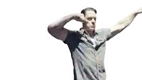 a man in a plaid shirt is covering his ears with his fist