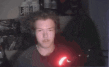 a blurry picture of a person 's face with a red light behind them