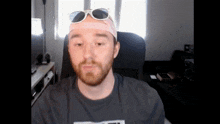 a man with a beard wearing sunglasses and a headband that says gucci