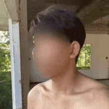 a man without a shirt is standing in front of a white building