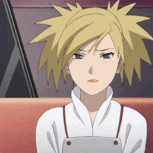 a girl with blonde hair and a white shirt is sitting on a couch