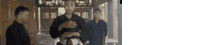 a blurry picture of three men standing next to each other .