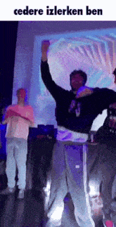 a group of people are dancing in front of a projection screen that says ' cedere izlerken ben '