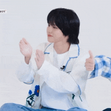 a person giving a thumbs up with the word eos visible in the corner