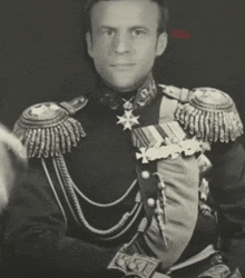 a black and white photo of a man in a military uniform with the letter k on his belt