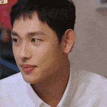 a close up of a man 's face with a sticker that says ' korean ' on it