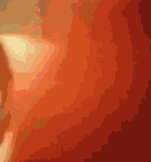 a close up of a person 's ear against a red background