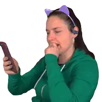 a woman wearing a cat ear headband and headphones looks at her phone