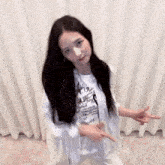 a woman with long black hair is wearing a white shirt with the word ballet on it .