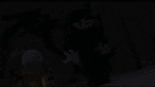 a minecraft character is standing in a dark room with a glowing light behind him .