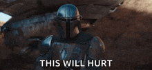 a man in a helmet is holding a gun with the words `` this will hurt '' written on the bottom .
