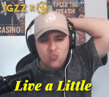 a man wearing headphones with the words live a little on the bottom