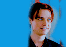 a close up of a man 's face with blue background